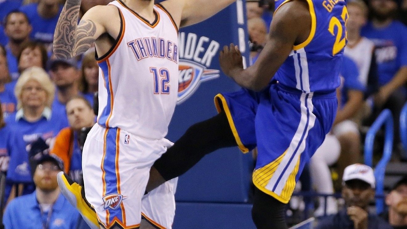 Draymond Green (right) kicks Steven Adams in the groin in 2016 [Source: AP]