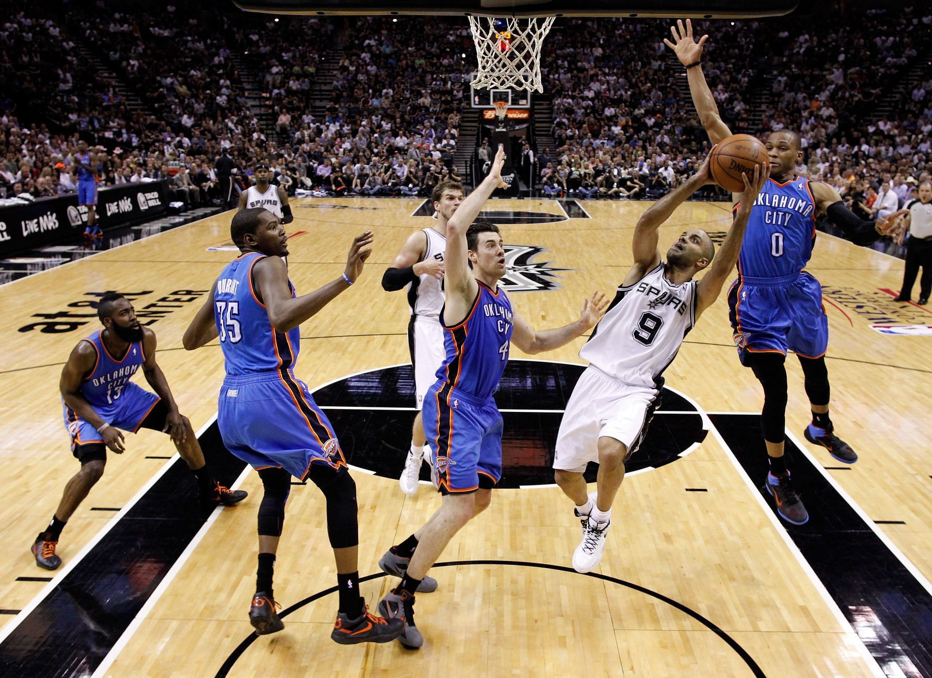 Tony Parker #9 of the San Antonio Spurs goes up for a shot in front of Russell Westbrook #0 of the Oklahoma City Thunder