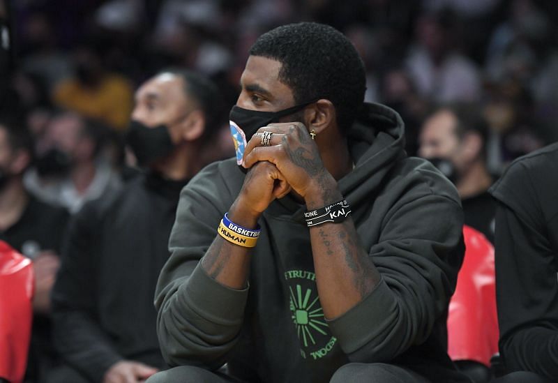 Kyrie Irving sits on the bench while watching the Brooklyn Nets and LA Lakers&#039; preseason opener