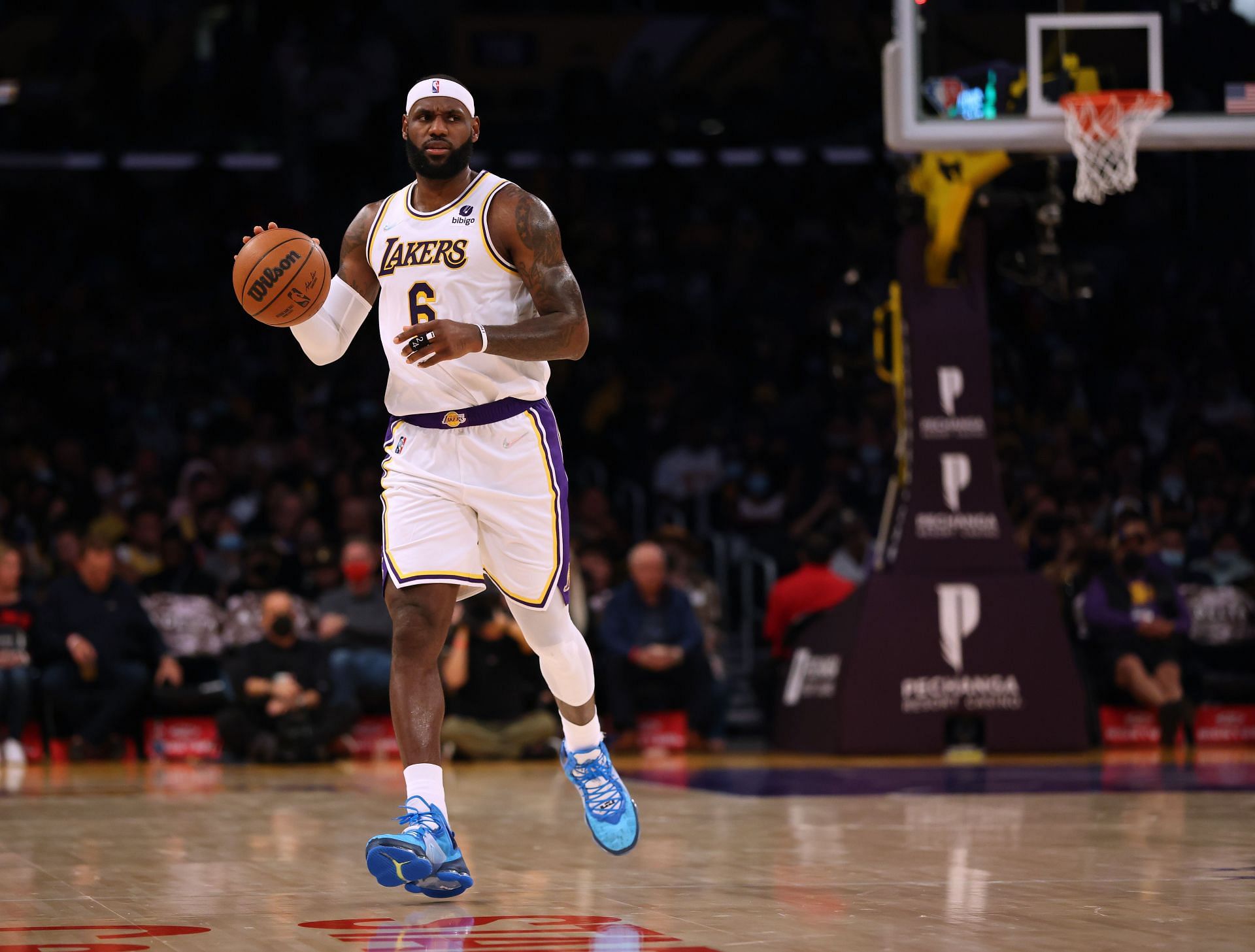 Los Angeles Lakers superstar LeBron James dribbling the ball while surveying the court