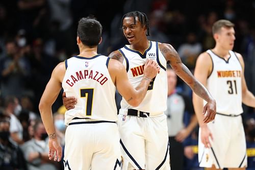 Nah'Shon Hyland #3 of the Denver Nuggets reacts with Facundo Campazzo #7 during the fourth quarter against the Minnesota Timberwolves at Ball Arena on October 8, 2021 in Denver, Colorado.