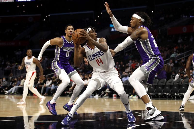 Terance Mann (#14) of the LA Clippers drives to the basket against Richaun Holmes of the Sacramento Kings/