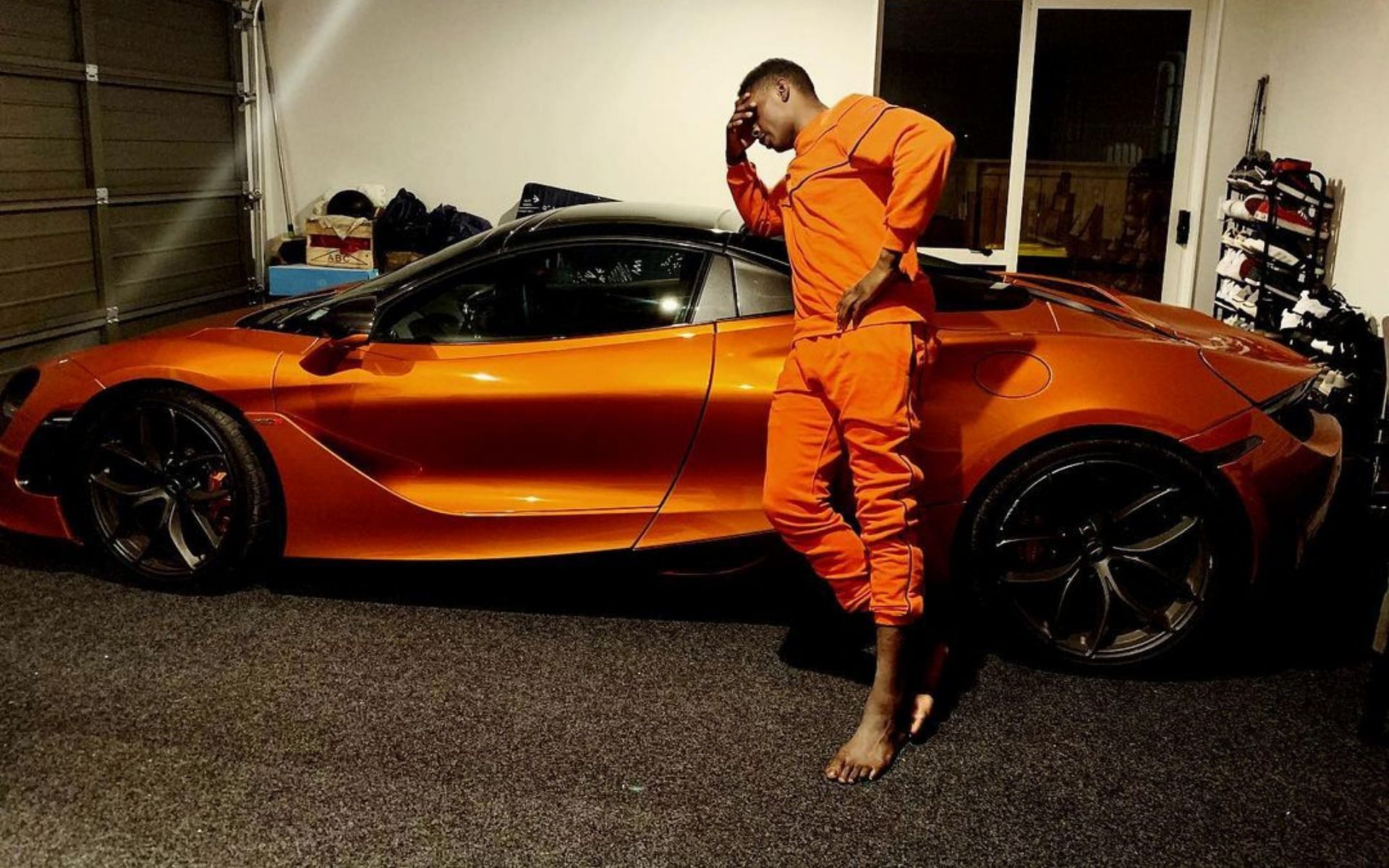 Israel Adesanya posing with his McLaren 720s Spider [Image credits: @stylebender on Instagram]