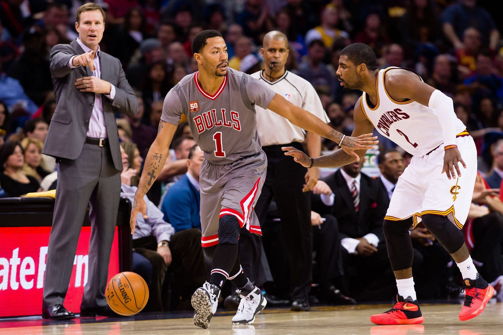 Derrick Rose (#1) of the Chicago Bulls drives around Kyrie Irving (#2) of the Cleveland Cavaliers