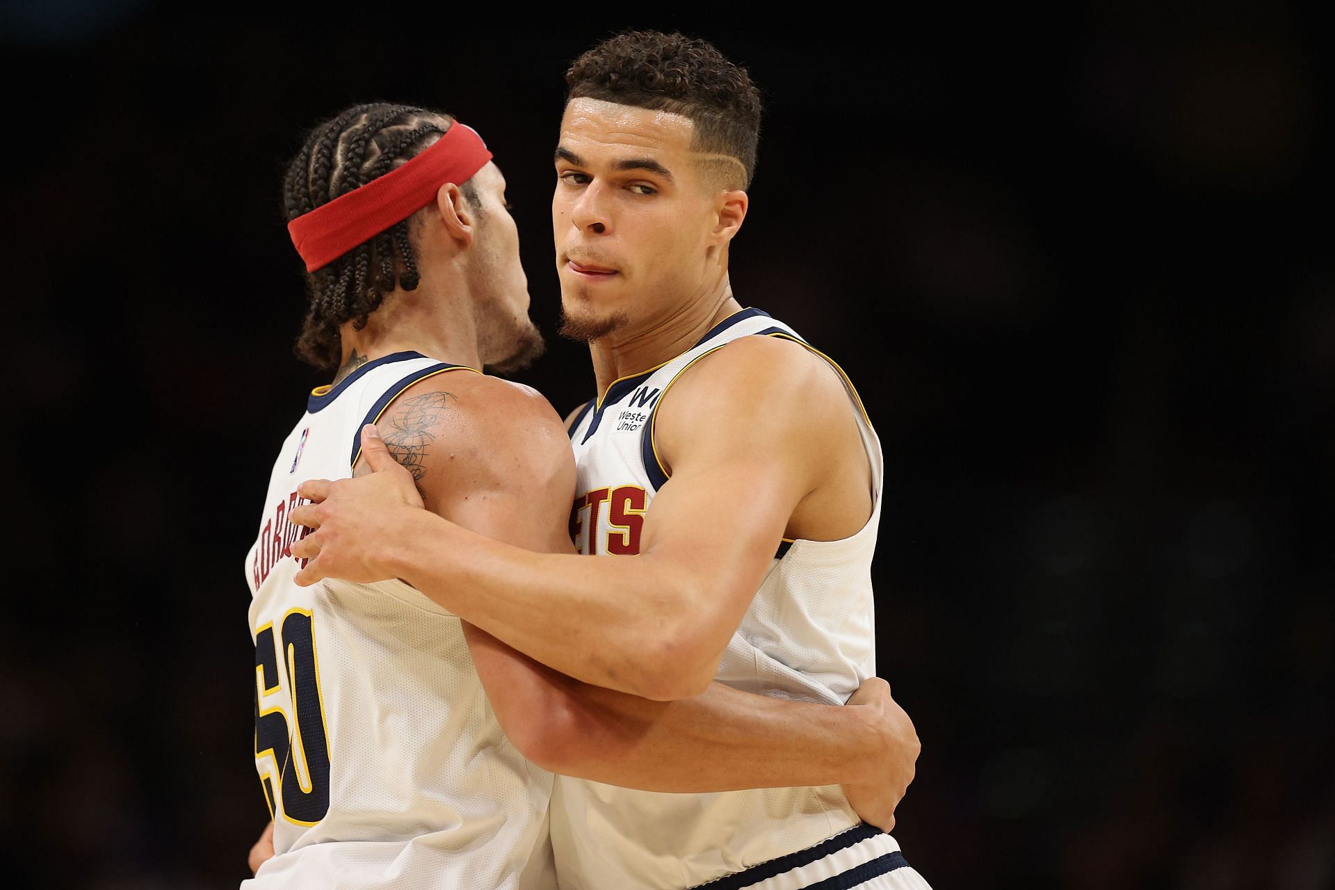 Aaron Gordon and Micahel Porter Jr. of the Denver Nuggets hug during their season opener