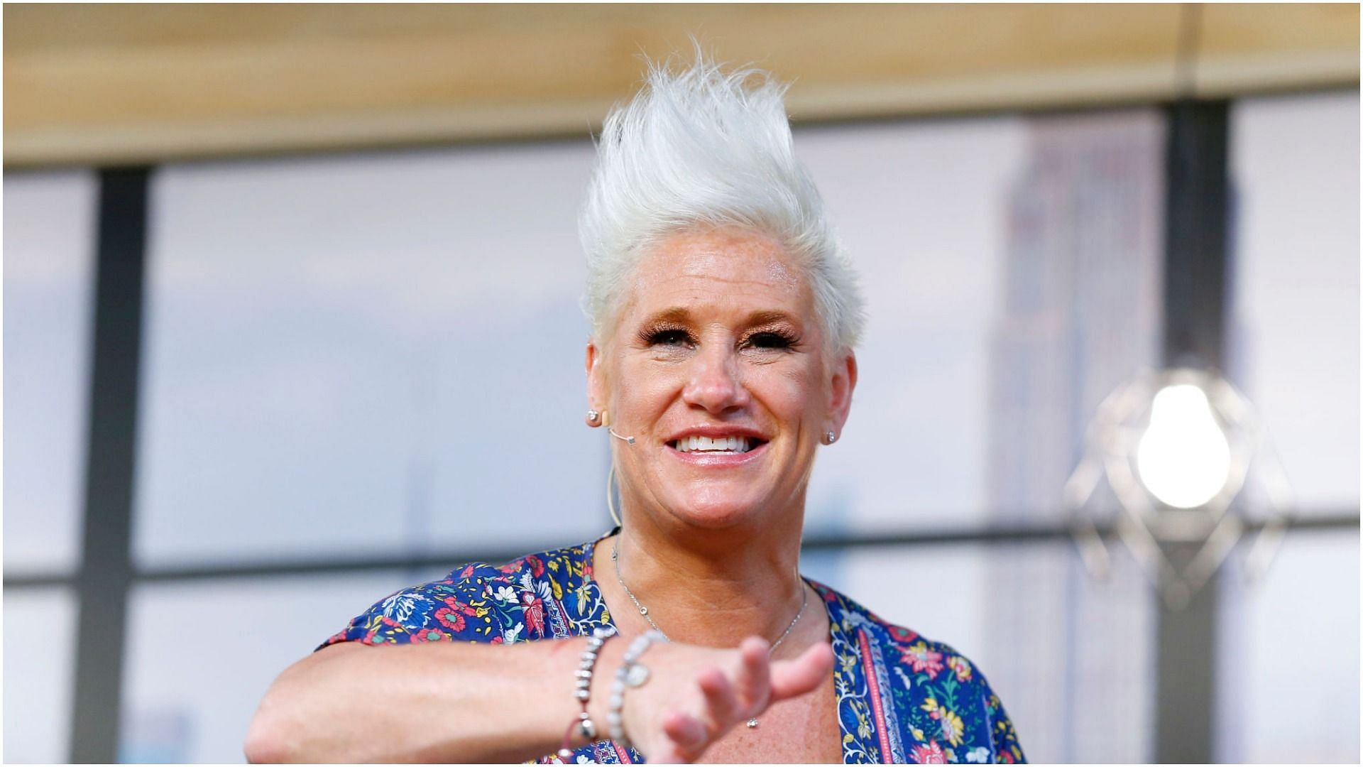 Anne Burrell prepares a dish on stage for a culinary demonstration during the Grand Tasting (Image via Getty Images)