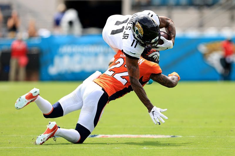 Denver Broncos safety Kareem Jackson tackles Jacksonville Jaguars receiver Marvin Jones Jr.