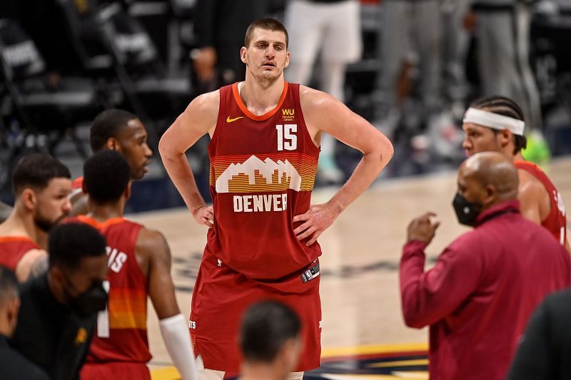 Nikola Jokic looks on at the Denver Nuggets bench during a timeout