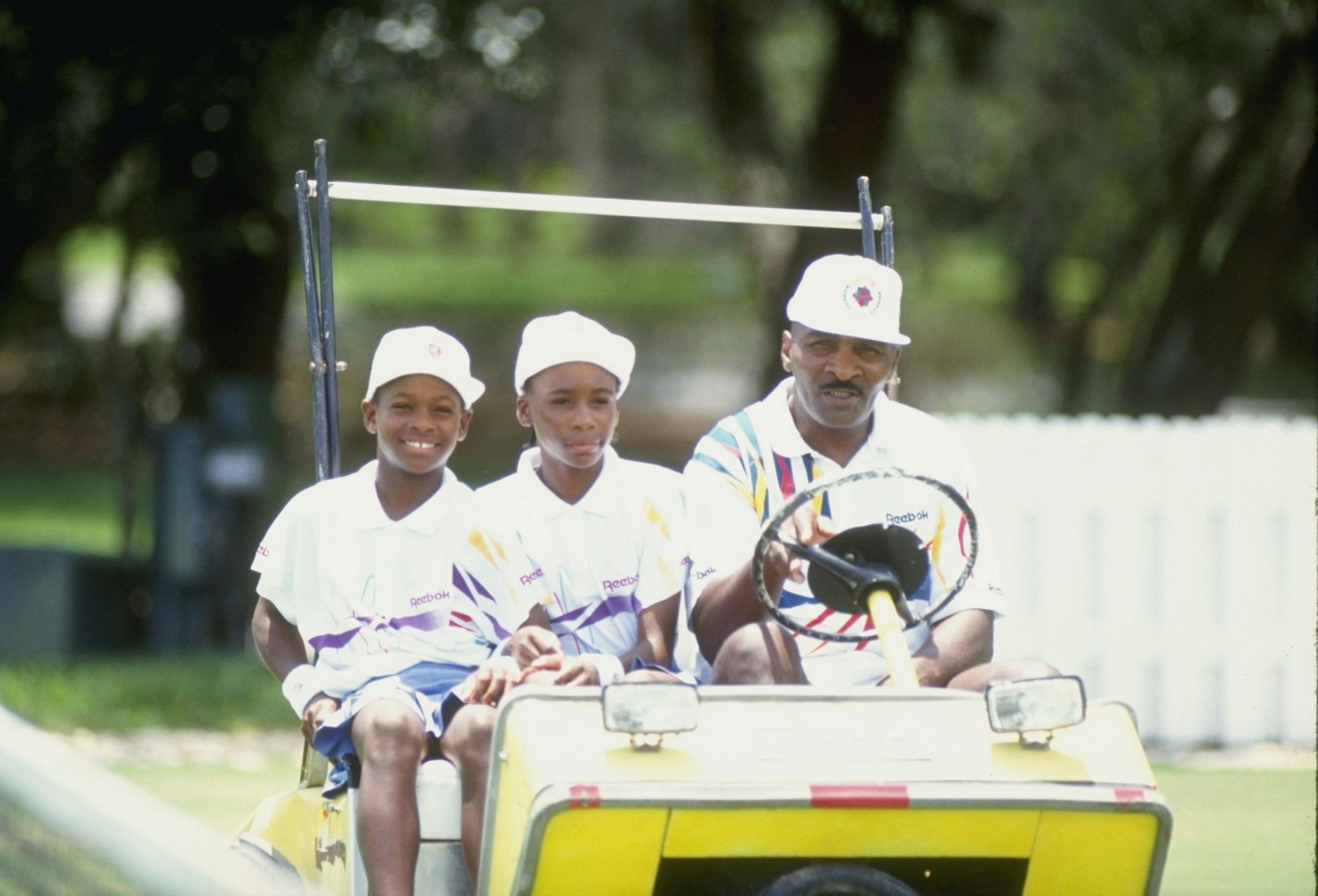 Serena (L) and Venus Williams at a tennis camp in Florida with father Richard Williams in 1992.