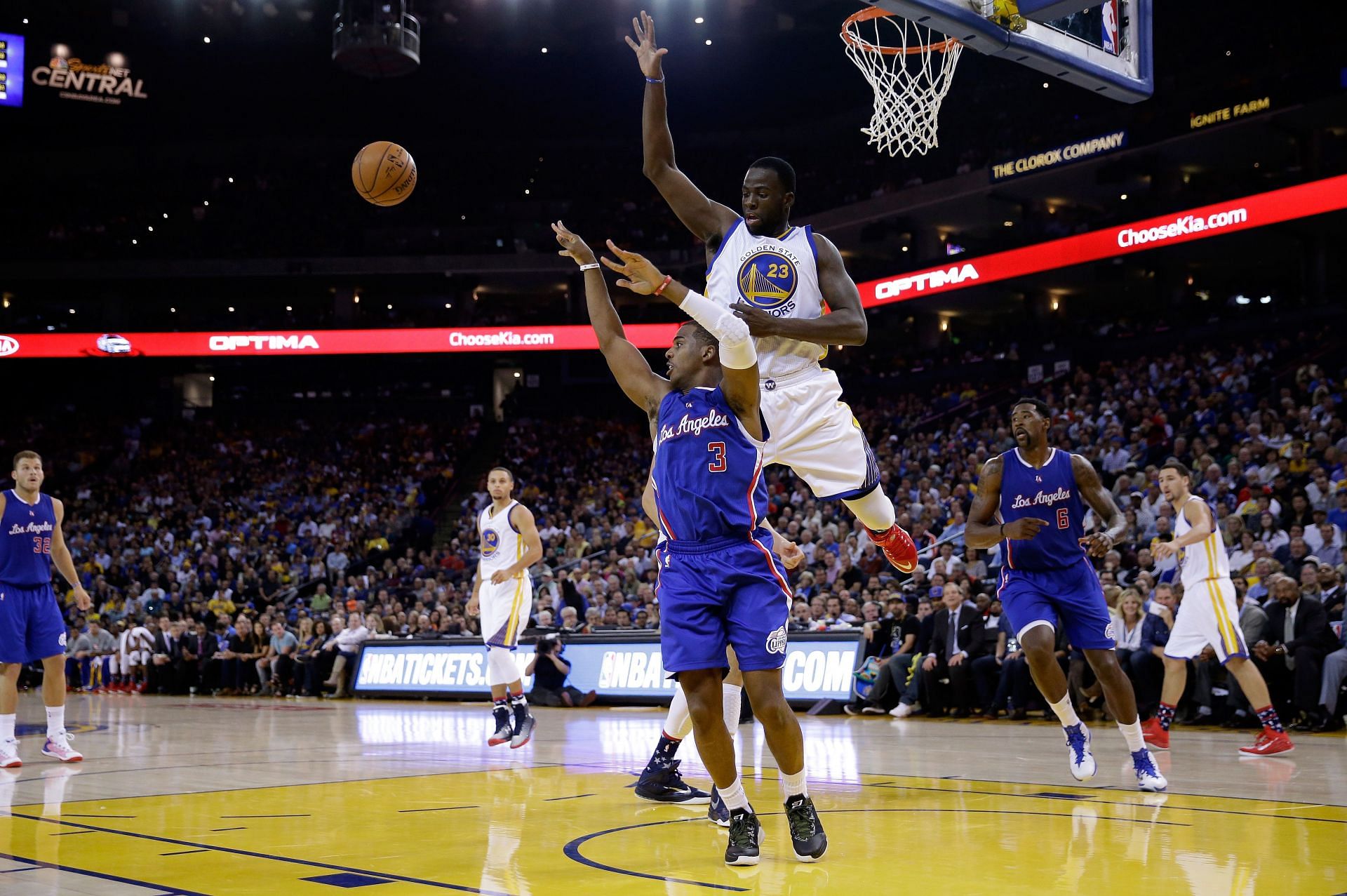 Chris Paul #3 of the Los Angeles Clippers passes the ball while defended by Draymond Green #23 of the Golden State Warriors.