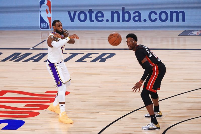 LeBron James #23 of the Los Angeles Lakers passes the ball against Bam Adebayo #13 of the Miami Heat