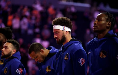 Klay Thompson (with the headband) of the Golden State Warriors before a game.