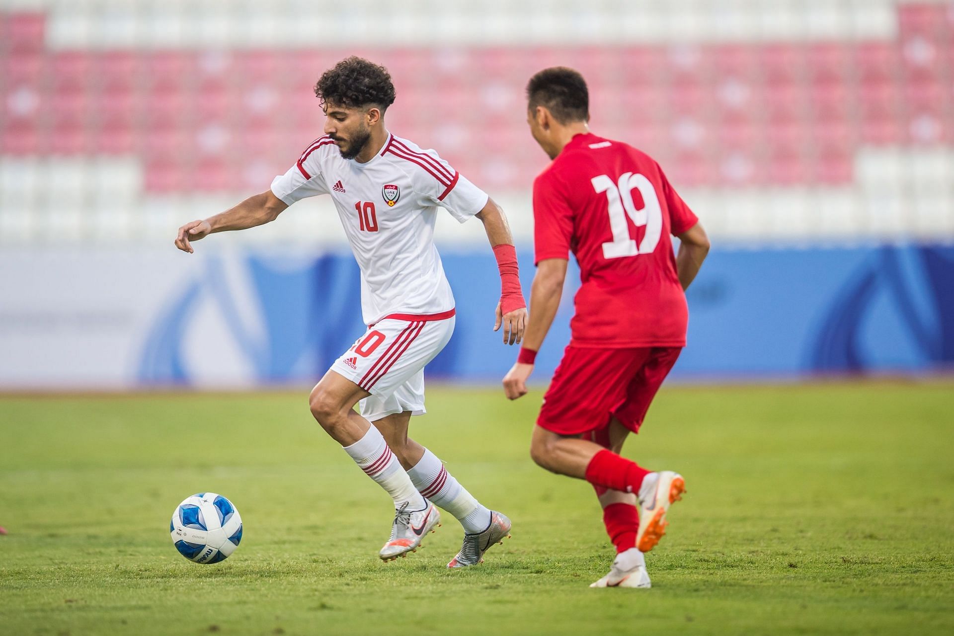 Khalid Al-Balochi (in white) scored the only goal for UAE in their 1-2 loss to Kyrgyzstan. (Image - @UAEFNT)
