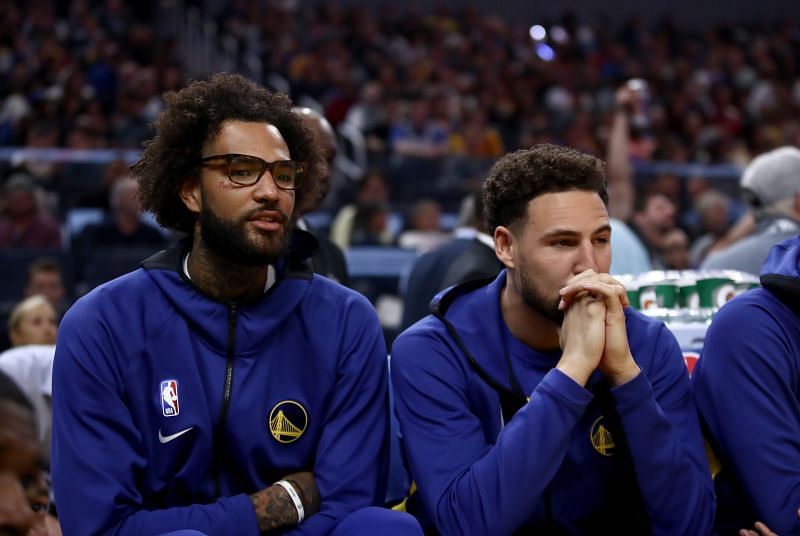 Injured Willie Cauley-Stein #2 and Klay Thompson #11 sit on the bench during their game against the Los Angeles Lakers at Chase Center on October 05, 2019 in San Francisco, California.