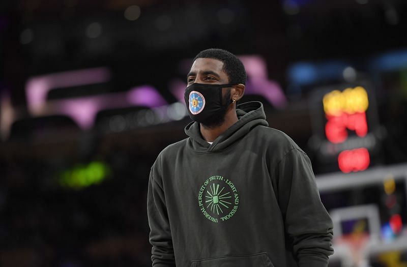 Kyrie Irving watching the proceedings as the Brooklyn Nets took on the Los Angeles Lakers in a preseason game.