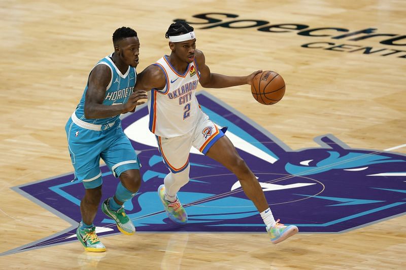 Shai Gilgeous-Alexander #2 of the Oklahoma City Thunder dribbles against Terry Rozier #3 of the Charlotte Hornets