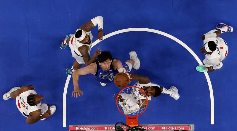 Dallas Mavericks center Boban Marjanovic fights for a rebound against the Clippers