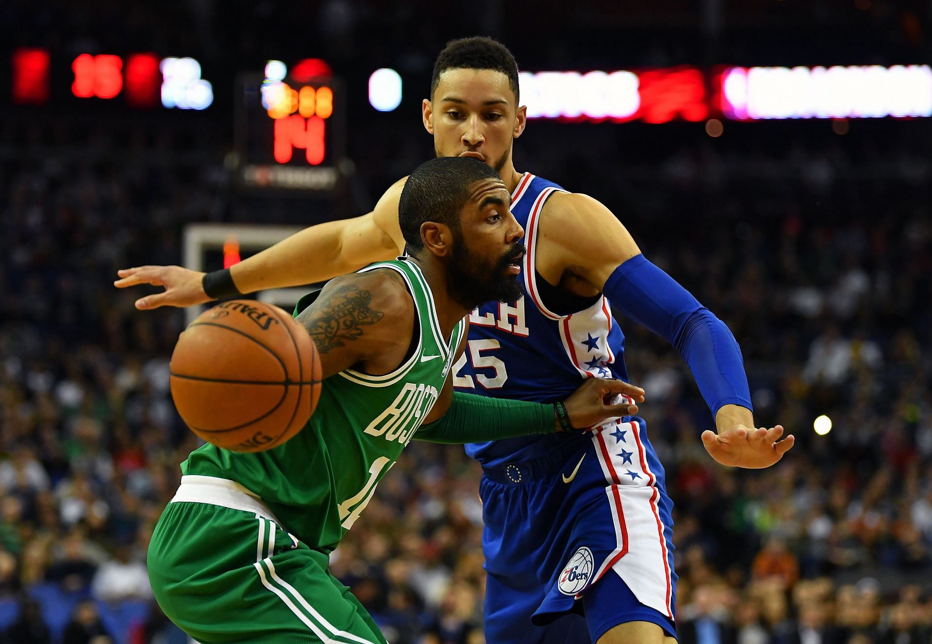 Ben Simmons guards Kyrie Irving during a game