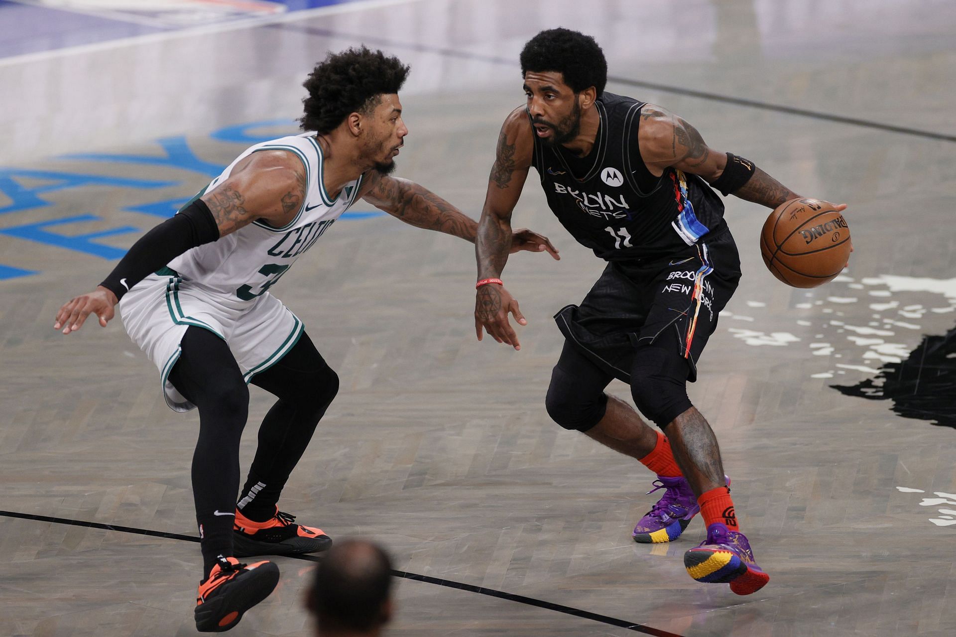Kyrie Irving (#11) of the Brooklyn Nets dribbles as Marcus Smart (#36) of the Boston Celtics defends.