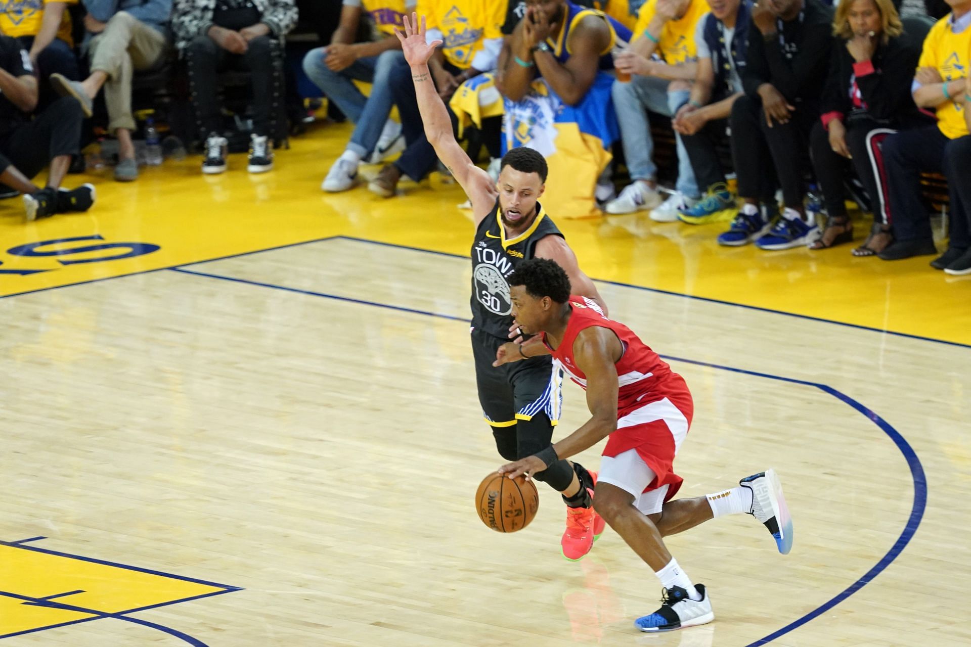 Kyle Lowry #7 of the Toronto Raptors is defended by Stephen Curry #30 of the Golden State Warriors during Game Six of the 2019 NBA Finals at ORACLE Arena on June 13, 2019 in Oakland, California.