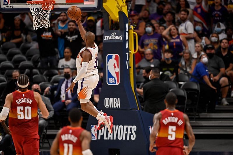 Chris Paul #3 of the Phoenix Suns scores on a fast break layup against the Denver Nuggets.
