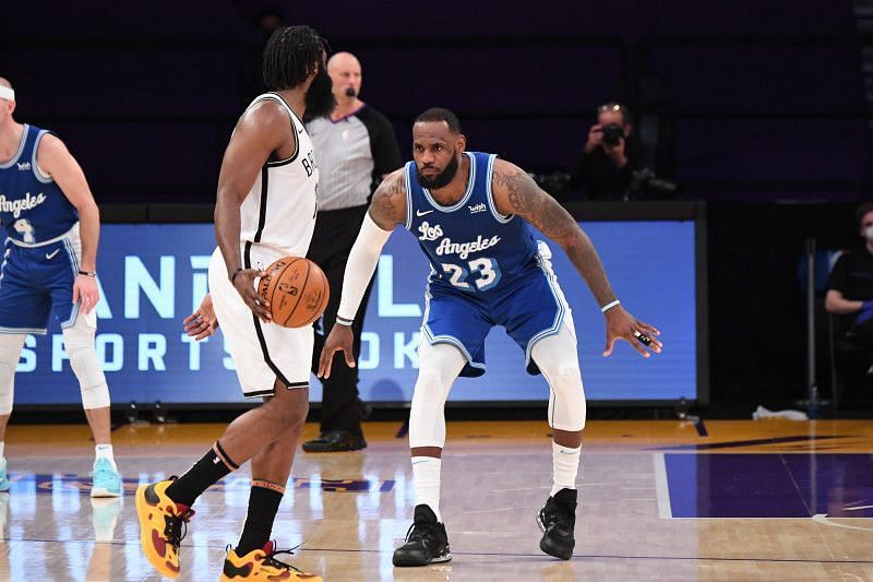 LeBron James of the LA Lakers guarding James Harden (in white) of the Brooklyn Nets
