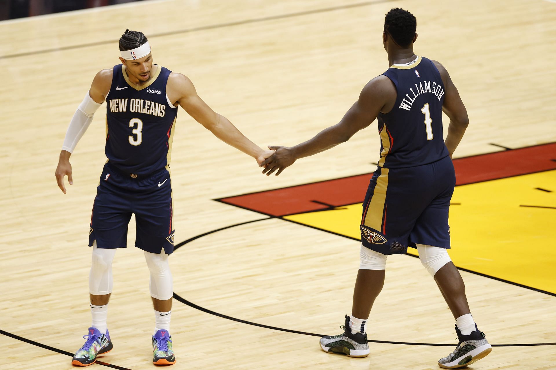 Josh Hart #3 of the New Orleans Pelicans celebrates a play with Zion Williamson #1 during the fourth quarter of a preseason game against the Miami Heat at American Airlines Arena on December 14, 2020 in Miami, Florida.