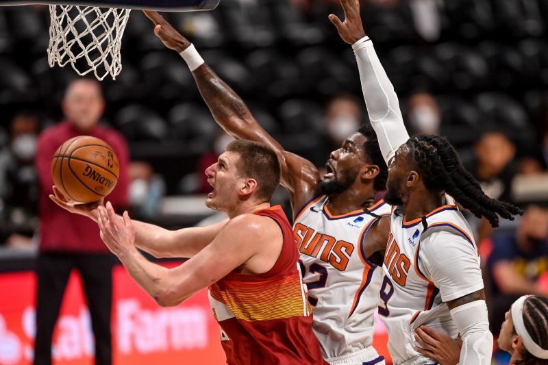 Nikola Jokic with a tough shot in tight coverage against the Phoenix Suns