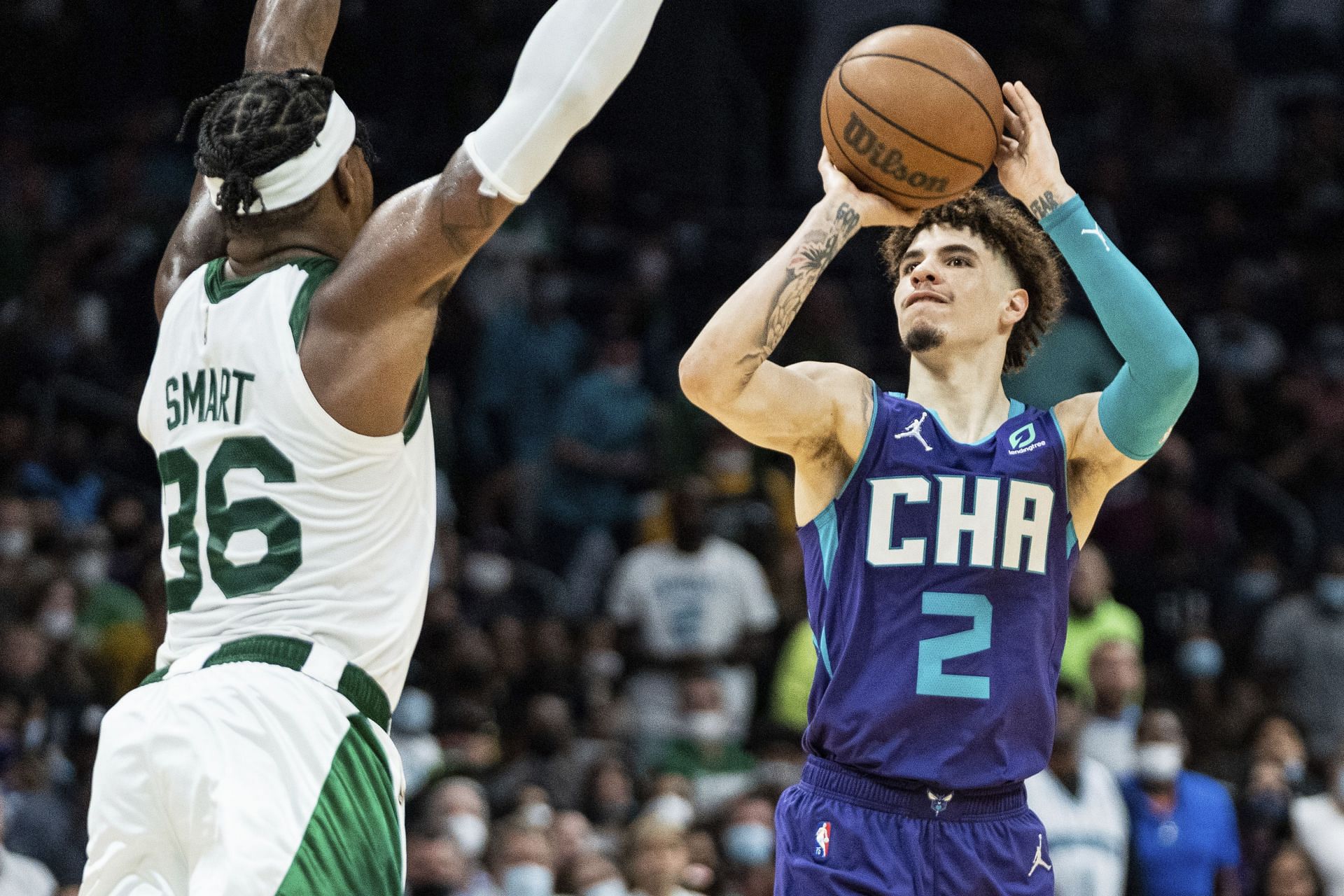 LaMelo Ball of the Charlotte Hornets attempts to shoot against Marcus Smart of the Boston Celtics. [Photo: MassLive.com]