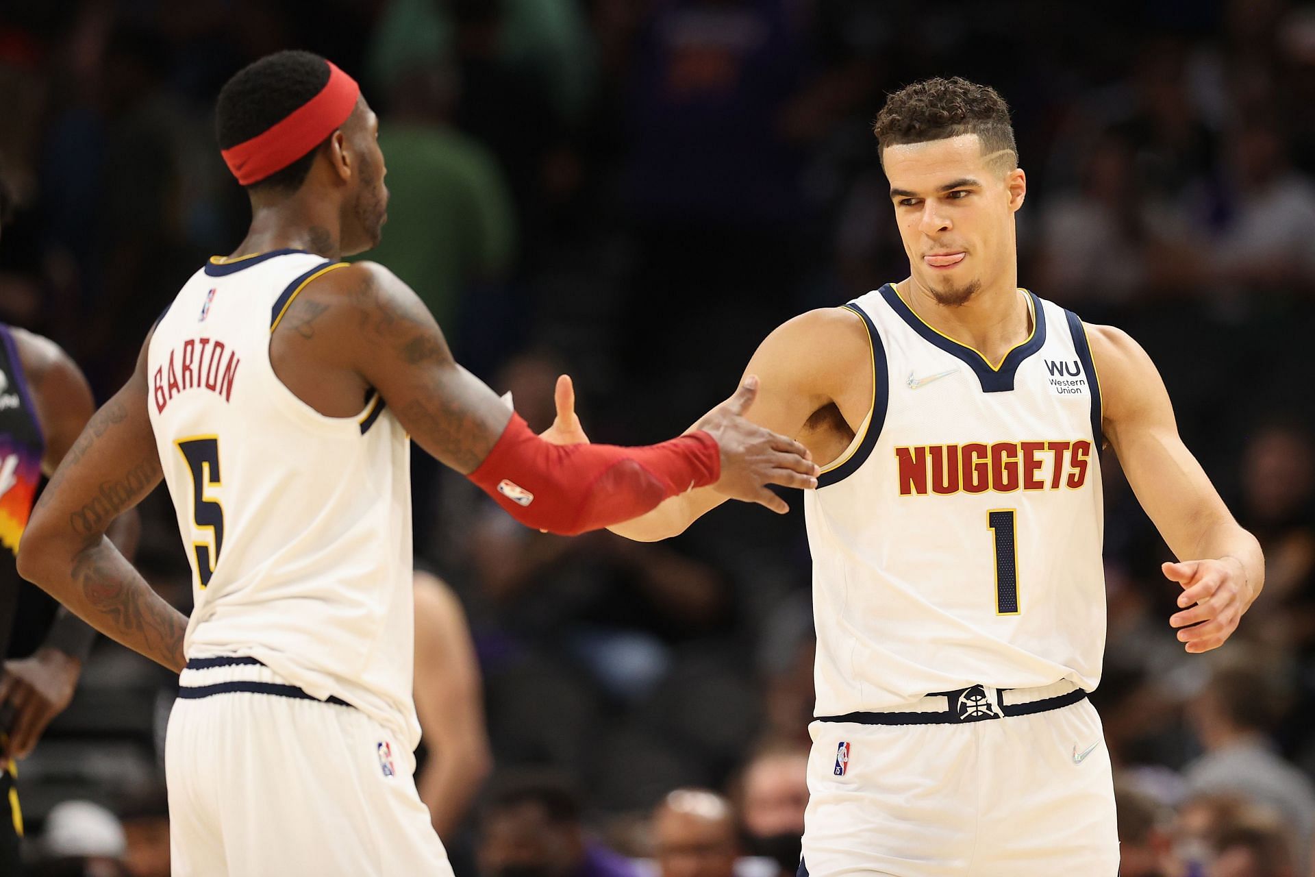 Michael Porter Jr. #1 and Will Barton #5 of the Denver Nuggets celebrate after defeating the Phoenix Suns