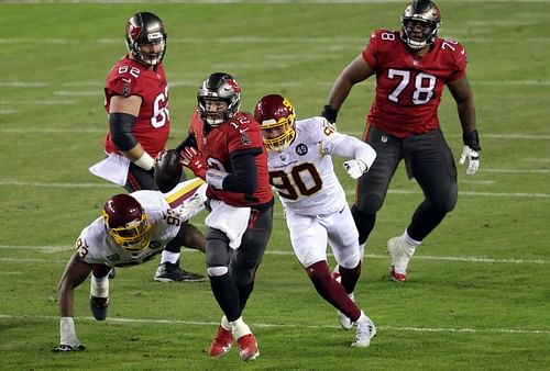 Tom Brady of the Tampa Bay Buccaneers sacked v Washington Football Team