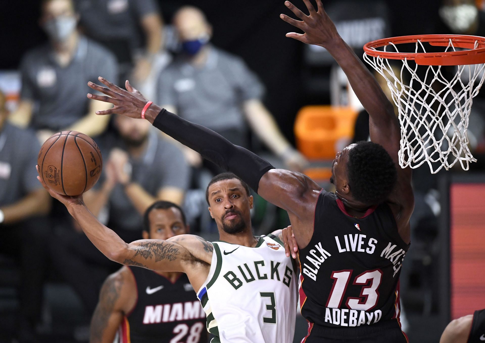 George Hill #3 of the Milwaukee Bucks drives to the basket against Bam Adebayo #13 of the Miami Heat during the fourth quarter in Game Four of the Eastern Conference Second Round during the 2020 NBA Playoffs at AdventHealth Arena at the ESPN Wide World Of Sports Complex on September 06, 2020 in Lake Buena Vista, Florida.