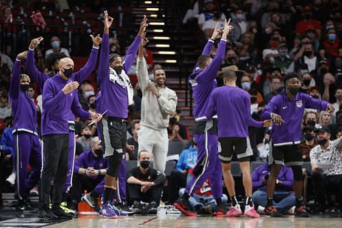 The Sacramento Kings bench reacts after a three-point basket against the Portland Trail Blazers.