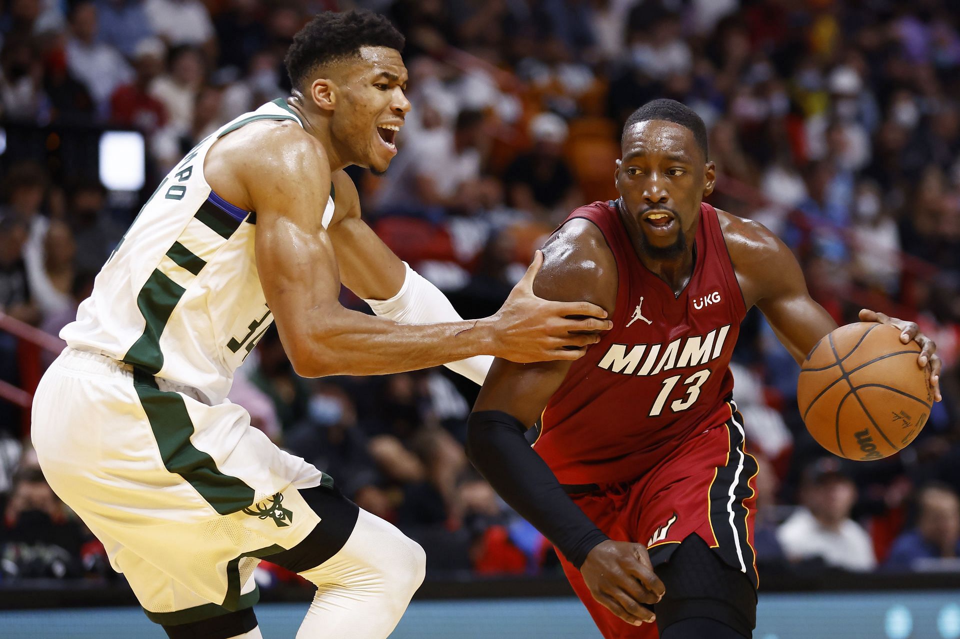 Miami Heat All-Star Bam Adebayo driving into the paint against Giannis Antetokounmpo