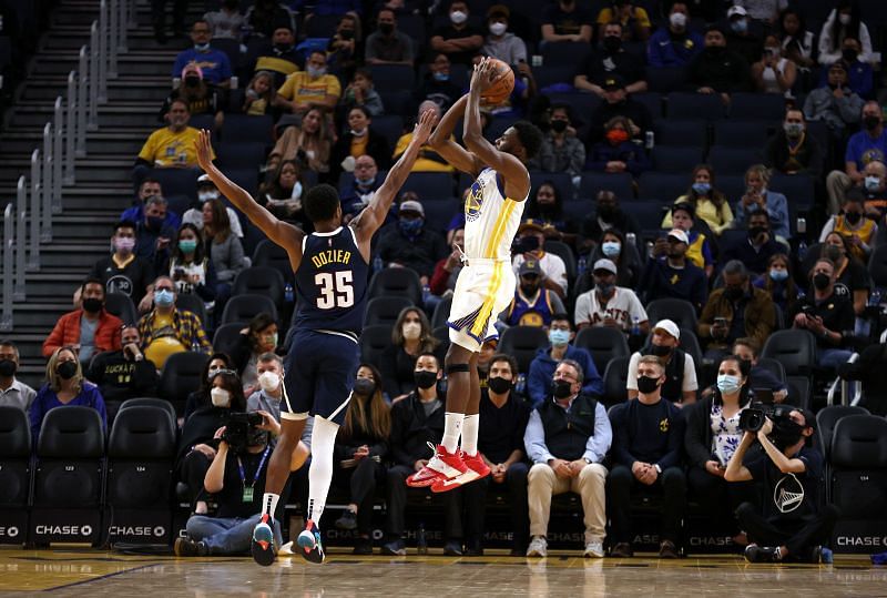 Andrew Wiggins shoots over PJ Dozier of the Denver Nuggets