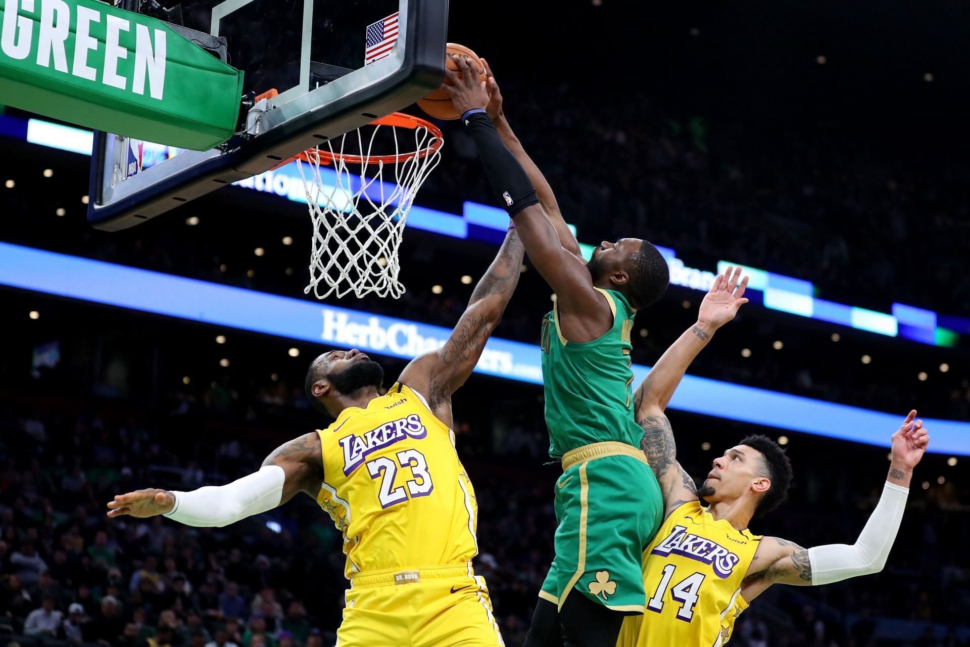 Jaylen Brown of the Boston Celtics muscles his way over LeBron James for a dunk