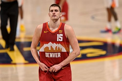 Nikola Jokic #15 of the Denver Nuggets walks off the court after having a word with Cameron Payne #15 of the Phoenix Suns after Jokic was ejected from the game in Game Four of the Western Conference second-round playoff series at Ball Arena on June 13, 2021 in Denver, Colorado.