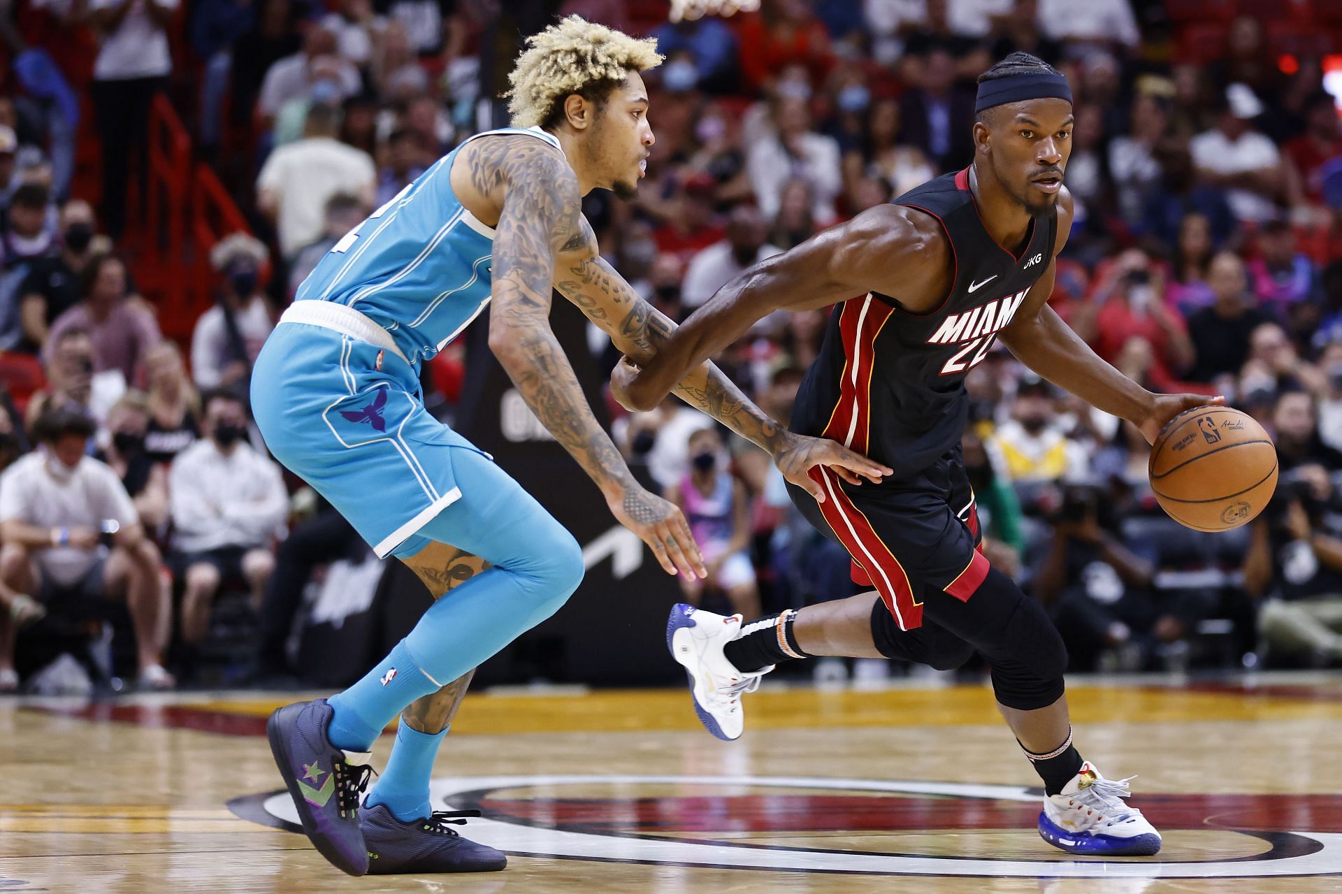 Miami Heat star Jimmy Butler dribbles past Charlotte Hornets&#039; Kelly Oubre