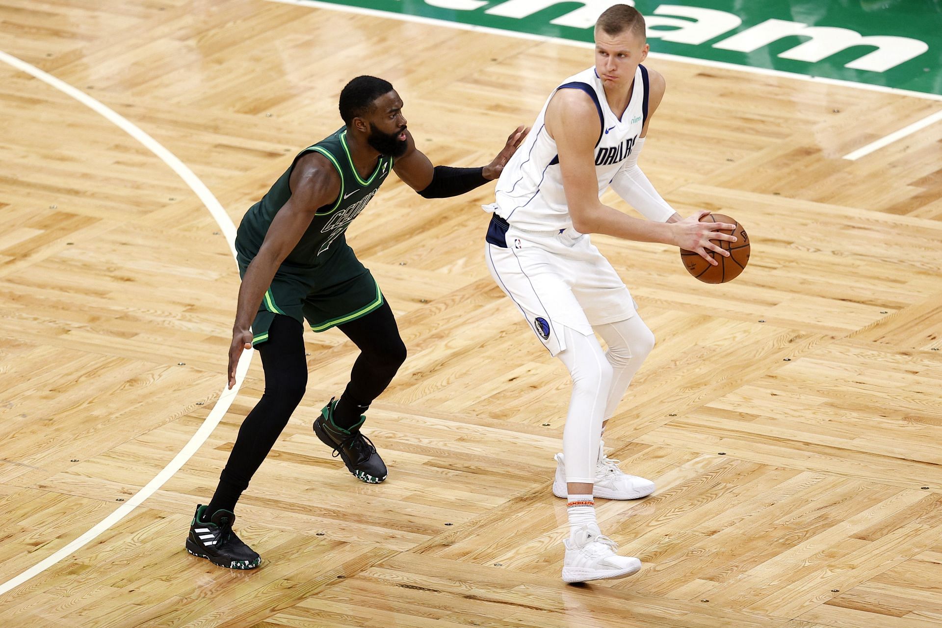 Dallas Mavericks big Kristaps Porzingis at the top of the key with the ball