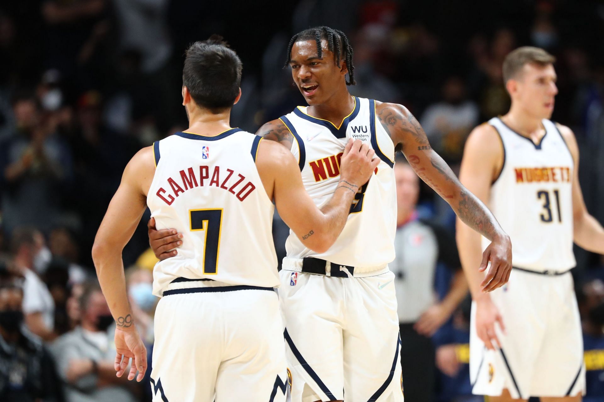 Nah&#039;Shon Hyland #3 of the Denver Nuggets reacts with Facundo Campazzo #7 during the fourth quarter against the Minnesota Timberwolves at Ball Arena on October 8, 2021 in Denver, Colorado.