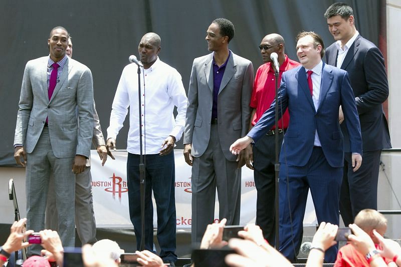 (L-R) Dwight Howard greets a large crowd of fans after he was introduced as a Houston Rocket along with former Houston Rocket greats Hakeem Olajuwon, Ralph Sampson, Elvin Hayes, Yao Ming and Houston Rockets general manager Daryl Morey (2R) on July 13, 2013 in Houston, Texas.