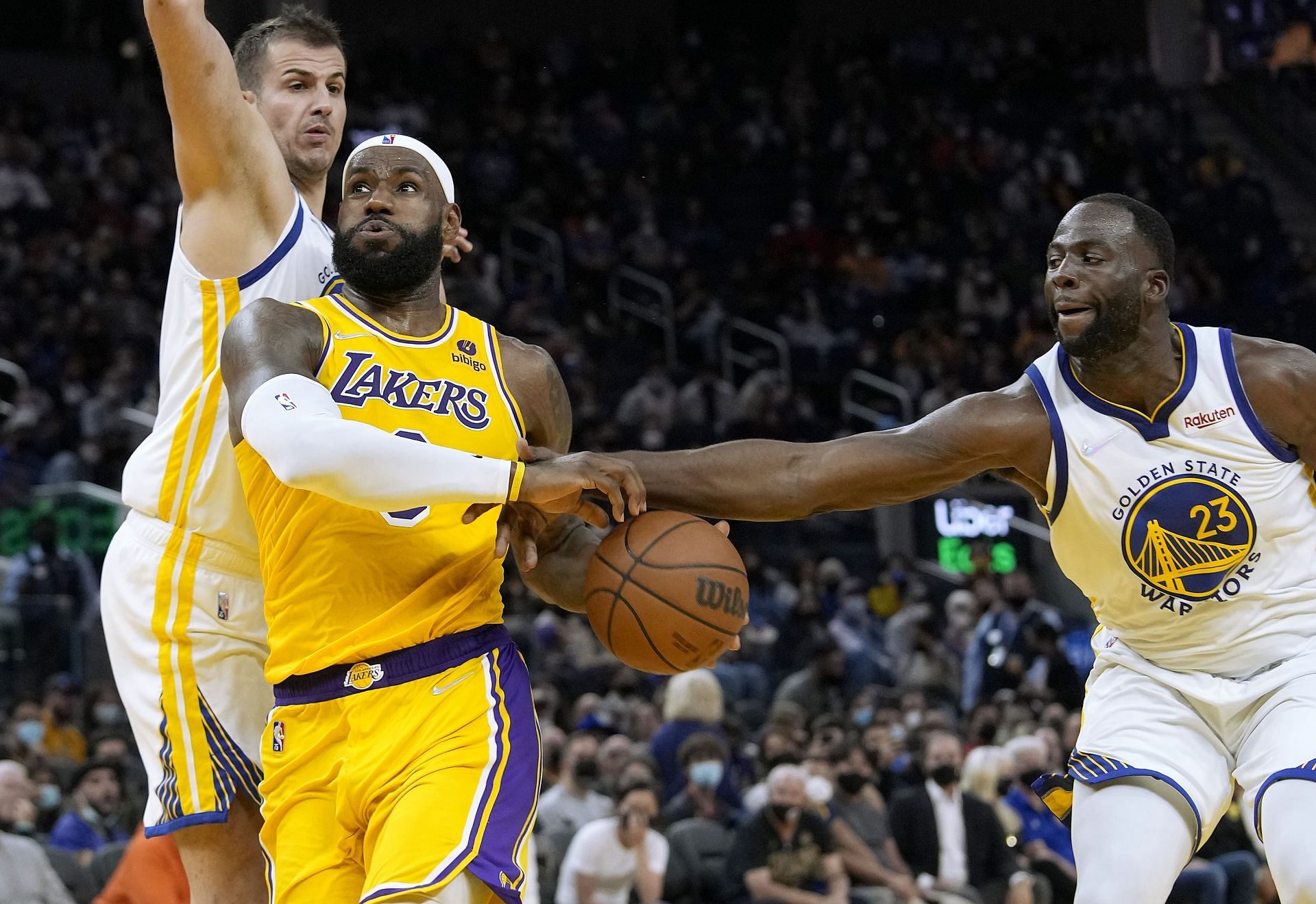 LeBron James of the LA Lakers drives past Draymond Green of the Golden State Warriors.