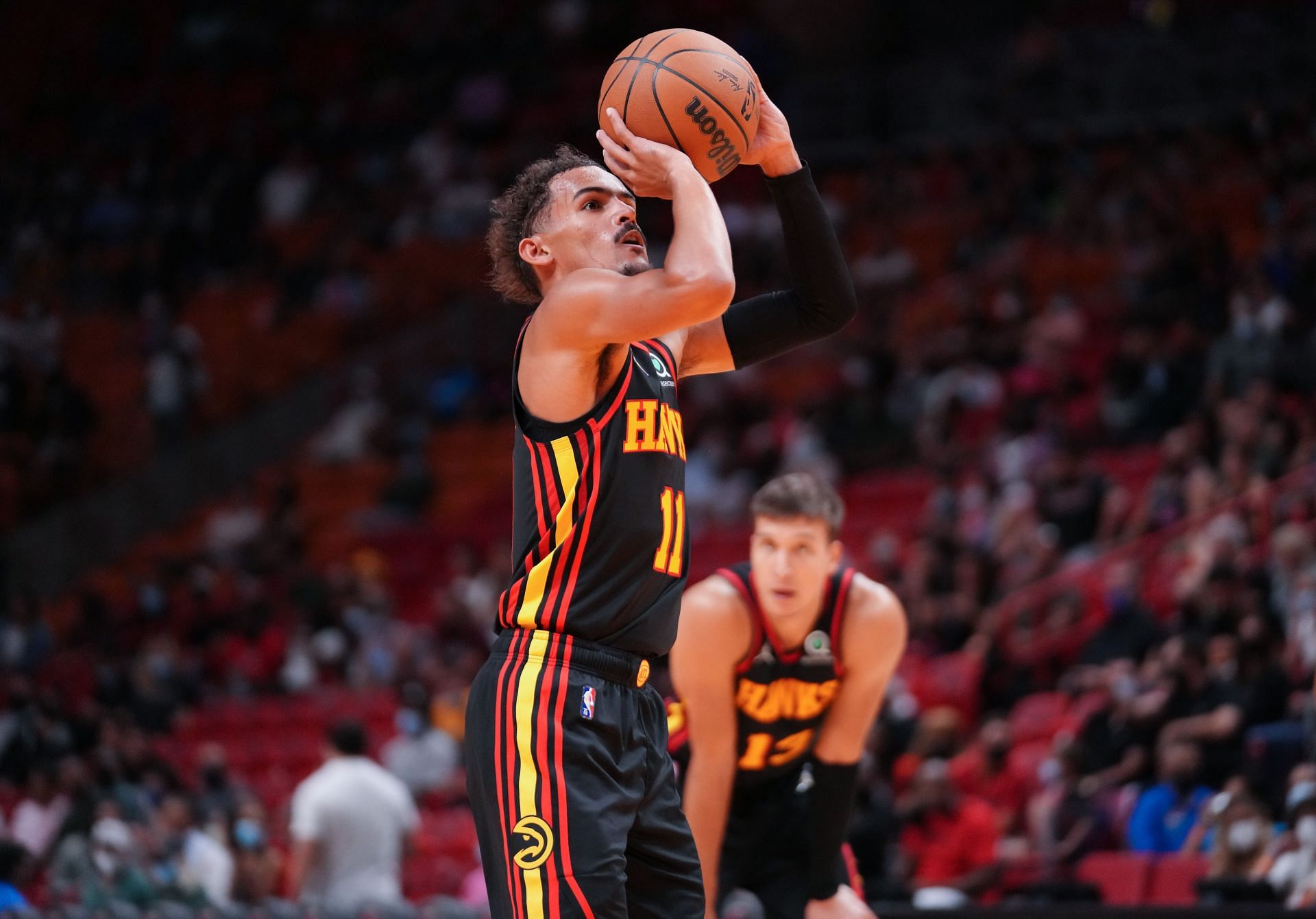Trae Young #11 of the Atlanta Hawks shoots a free throw in the second quarter against the Miami Heat in preseason action at FTX Arena on October 04, 2021 in Miami, Florida.