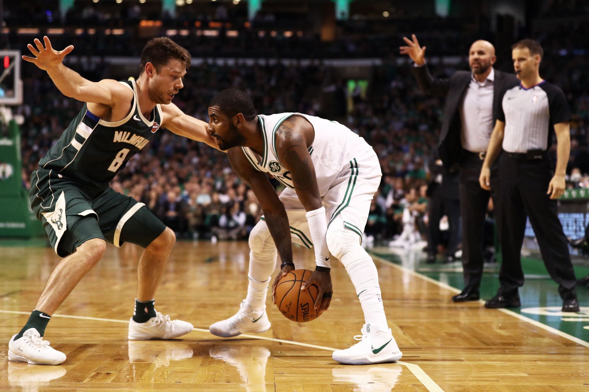 Matthew Dellavedova (#8) of the Milwaukee Bucks defends Kyrie Irving (#11) of the Boston Celtics