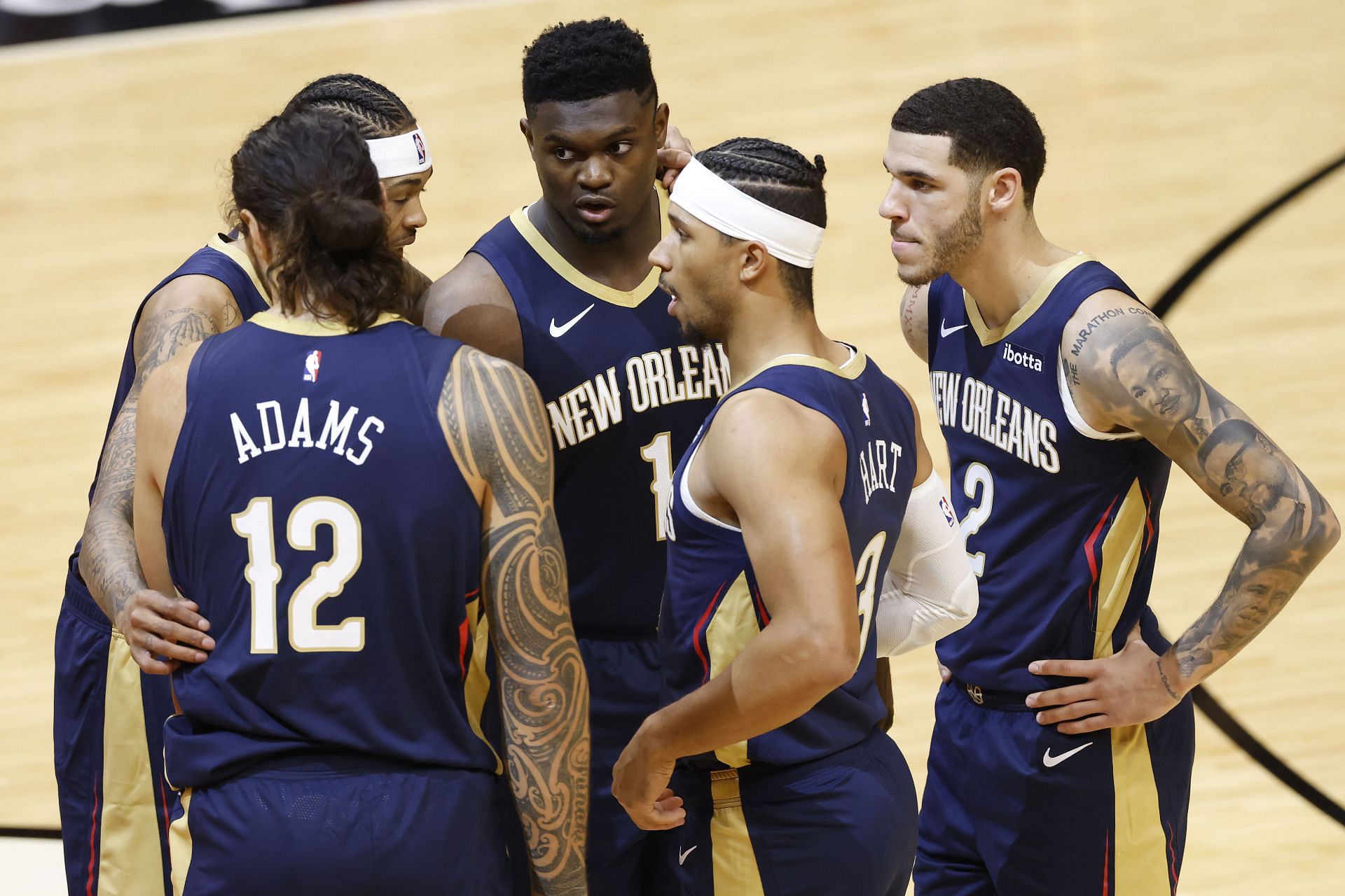 Steven Adams #12, Brandon Ingram #14, Zion Williamson #1, Josh Hart #3 and Lonzo Ball #2 of the New Orleans Pelicans huddle during the first quarter of a preseason game against the Miami Heat at American Airlines Arena on December 14, 2020 in Miami, Florida.