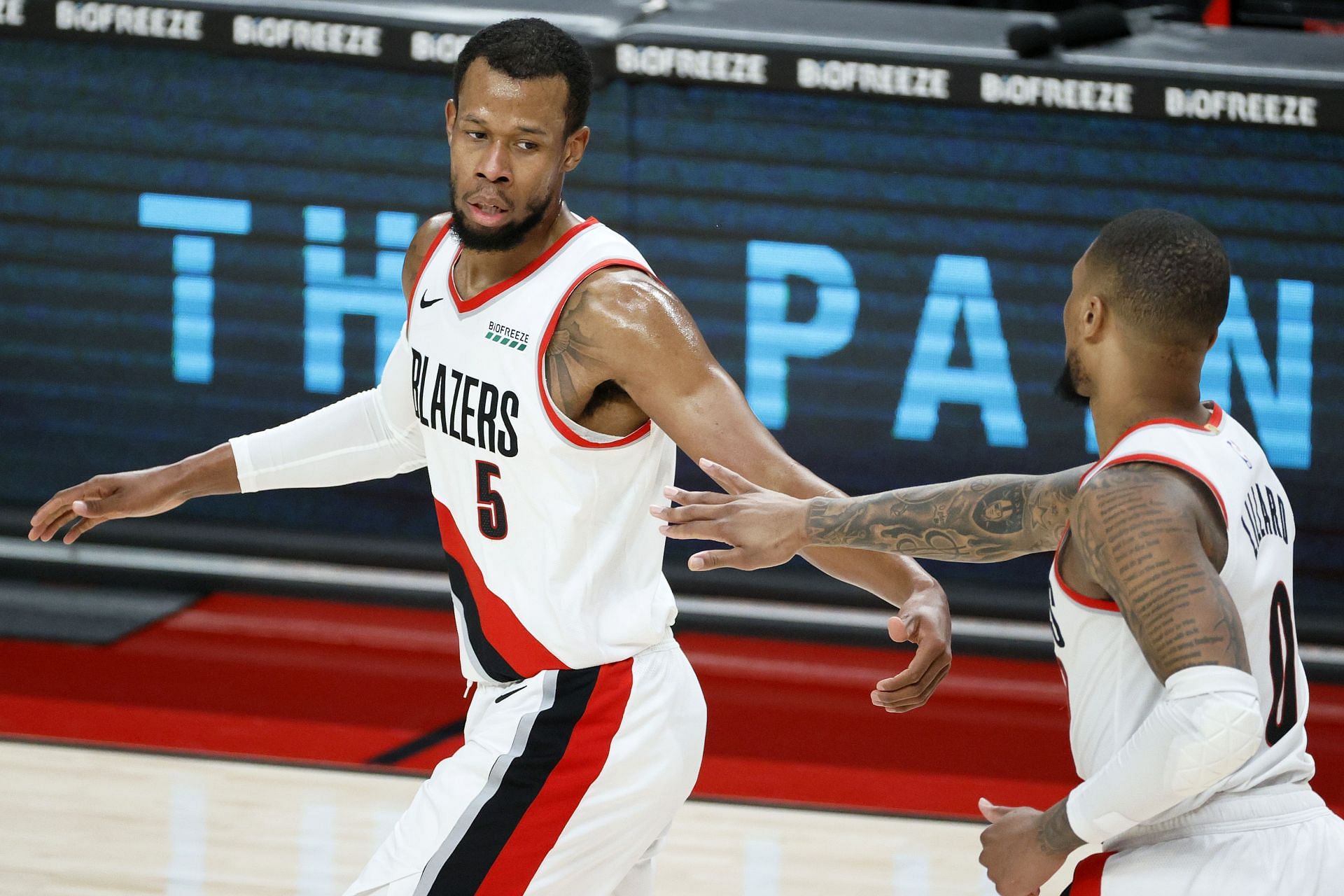 Rodney Hood #5 and Damian Lillard #0 of the Portland Trail Blazers high-five after a basket against the Dallas Mavericks 