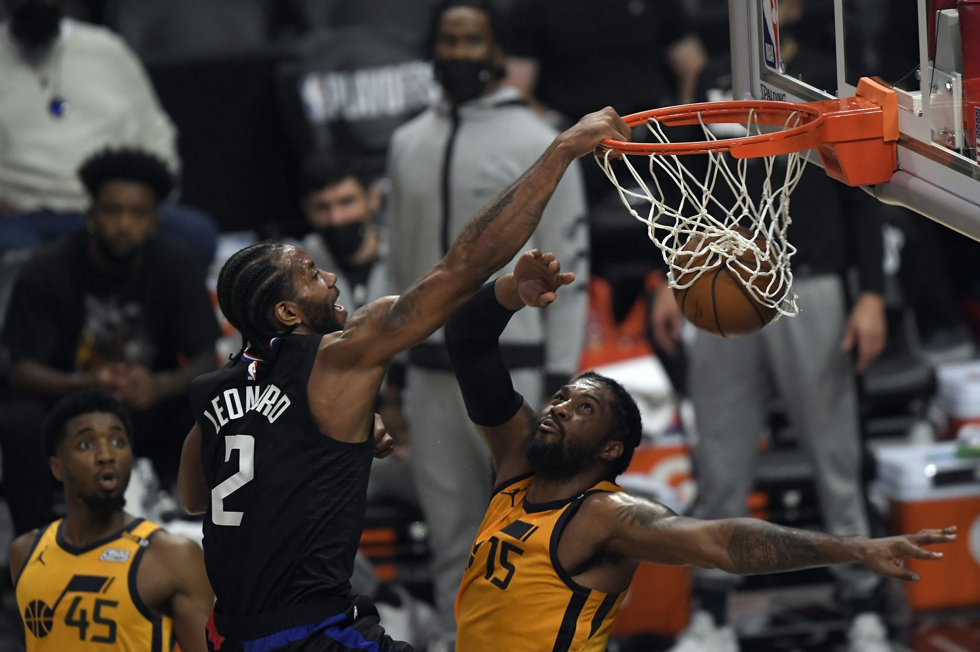 Kawhi Leonard #2 of the Los Angeles Clippers slam dunks against Derrick Favors #15 of the Utah Jazz during the first half in Game Four of the Western Conference second-round playoff series at Staples Center on June 14, 2021 in Los Angeles, California.