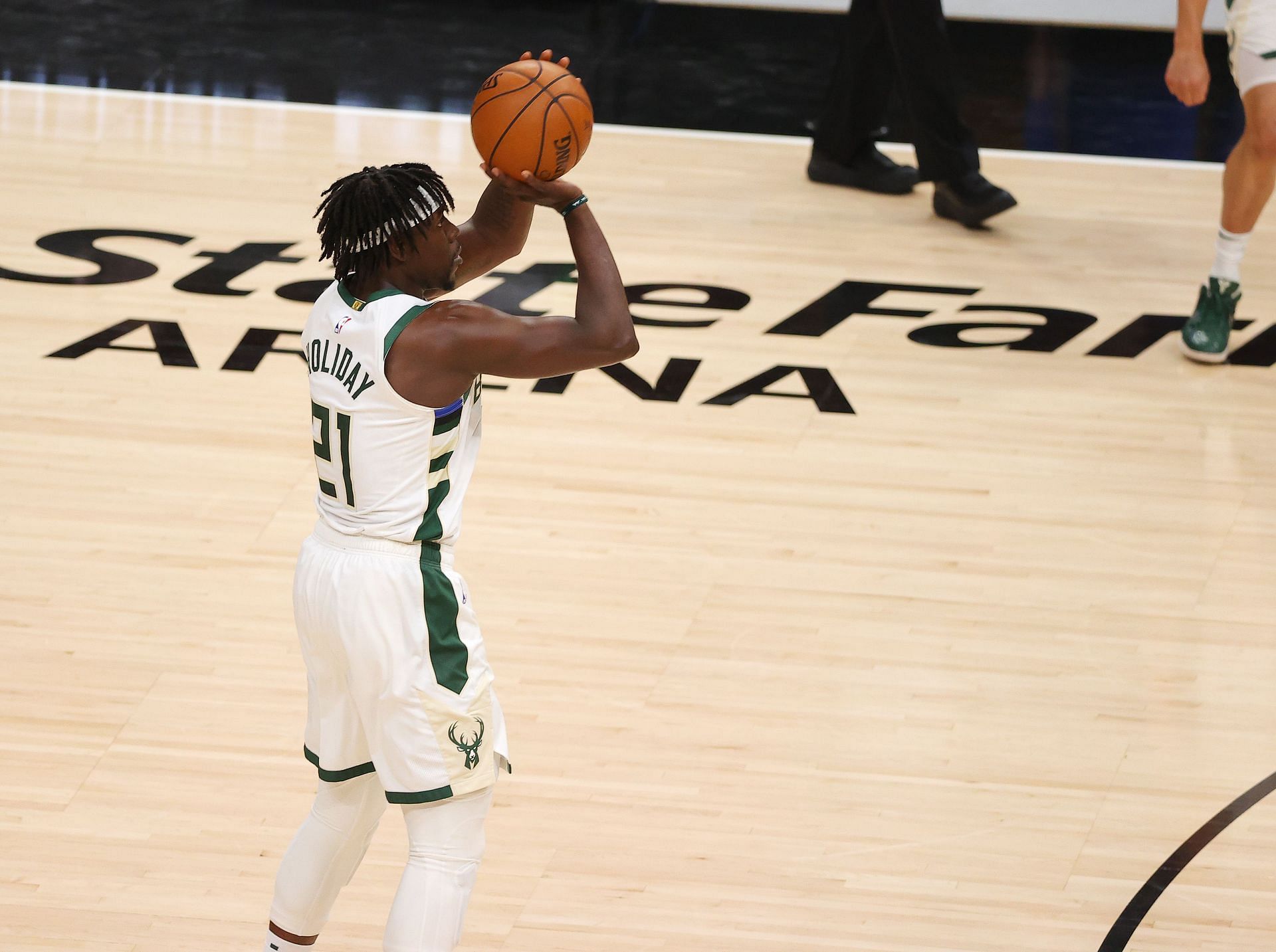 Jrue Holiday #21 of the Milwaukee Bucks shoots a three point basket against the Atlanta Hawks during the second half in Game Six of the Eastern Conference Finals at State Farm Arena on July 03, 2021 in Atlanta, Georgia.