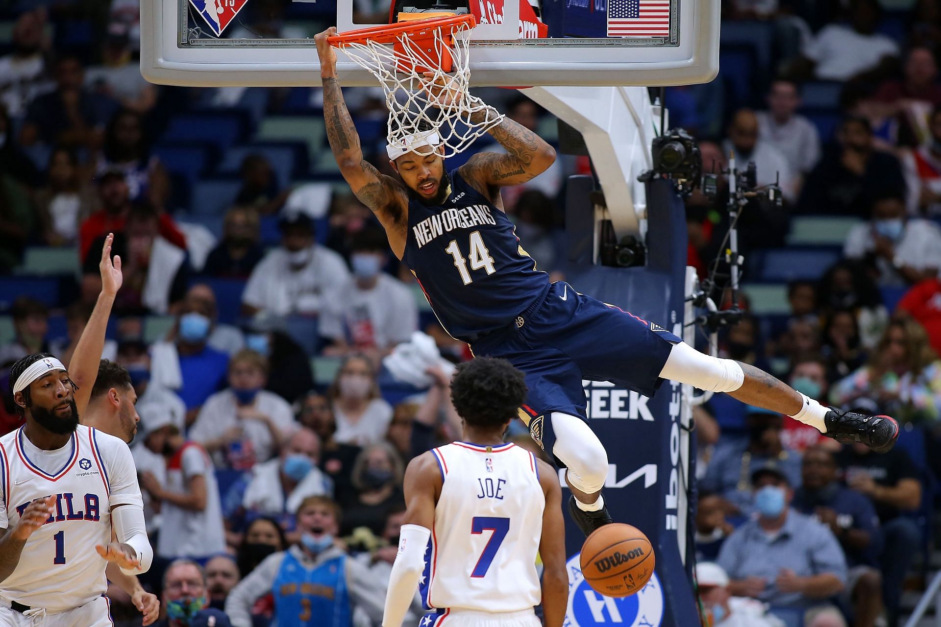 Brandon Ingram #14 of the New Orleans Pelicans dunks as Isaiah Joe #7 of the Philadelphia 76ers and Andre Drummond #1 defend during the second half at the Smoothie King Center on October 20, 2021 in New Orleans, Louisiana.