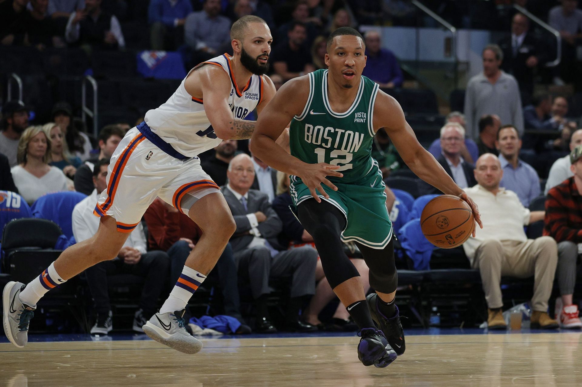 Grant Williams #12 of the Boston Celtics dribbles as Evan Fournier #13 of the New York Knicks defends